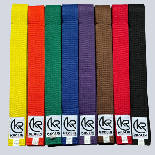 A collection of KROLIN martial arts belts in various colors, including yellow, orange, green, blue, purple, brown, and black, each with a label that says 'KROLIN'.